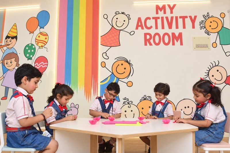 Young children doing a craft activity in the early years activity room at Dalimss Sunbeam