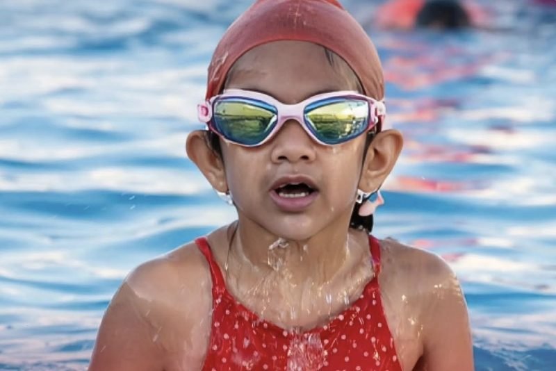 A young swimmer in goggles and a swim cap in the pool at Dalimss Sunbeam Rohania