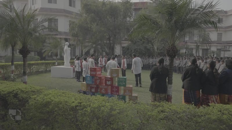 Students gathered on the green lawn for morning assembly