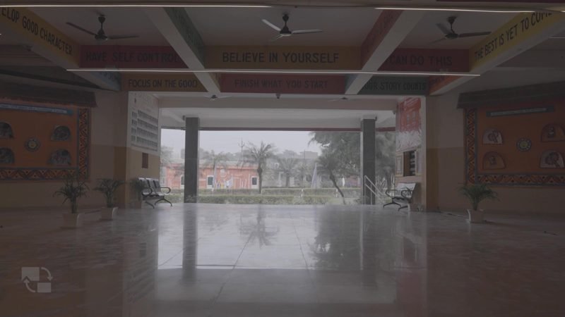Wide polished hall opening onto the campus grounds