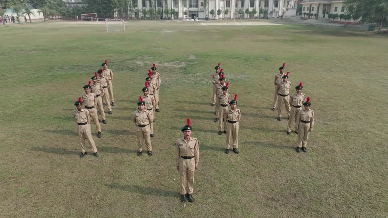 NCC cadets at drill on the playing field, seen from the air, Rohania