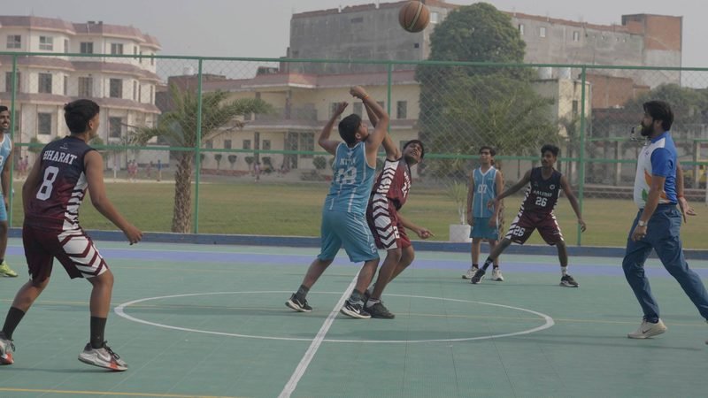 Students in a basketball match on the outdoor court, Rohania