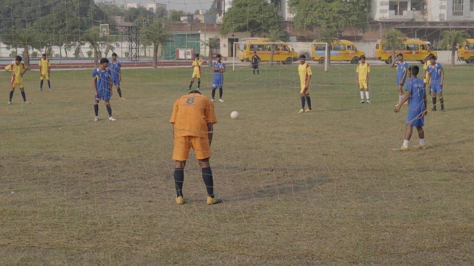Students playing football on the main playing field at Rohania