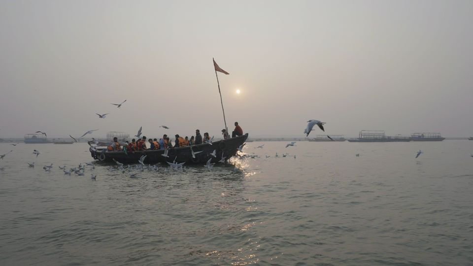 A boat of students on the Ganga at sunrise during a school trip to the ghats, Varanasi