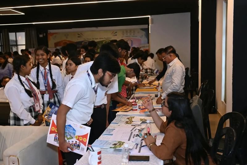 Students talking with university representatives at the career fair