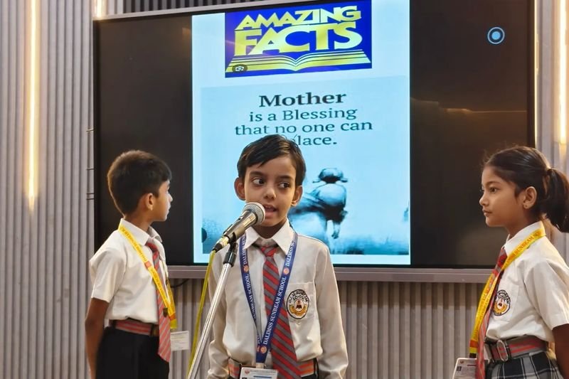 A junior student speaking at the microphone, Mahmoorganj