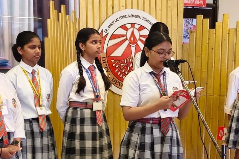 Students leading morning assembly at the microphone, Rohania