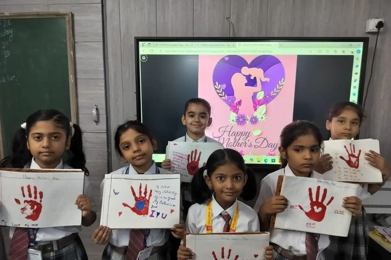 Students with their handprint artwork in class, Mahmoorganj